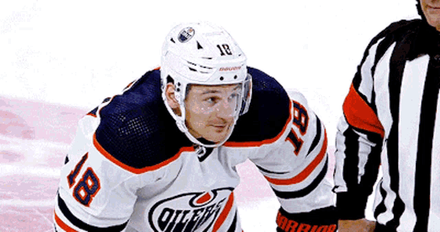 a hockey player with the number 18 on his shirt