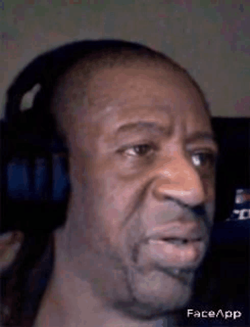 a close up of a man wearing headphones .
