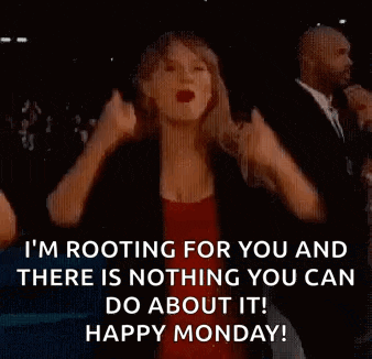 a woman in a red dress is raising her arms in the air while singing a song .