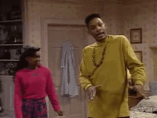 a man in a yellow shirt is standing next to a woman in a pink sweater and says mind ya business .