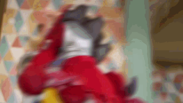 a blurry picture of a person wearing a red jacket and gloves