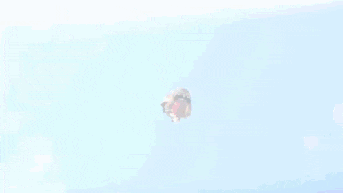 a man in a suit is flying through the air with his arms outstretched