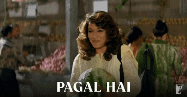 a woman is holding a watermelon in front of a sign that says pagal hai