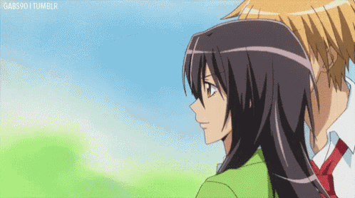 a boy and a girl are looking at each other and the girl is wearing a green jacket .