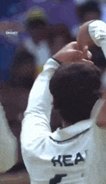 a man wearing a white shirt with the name kea on the back