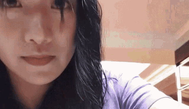 a close up of a woman 's face with her eyes closed