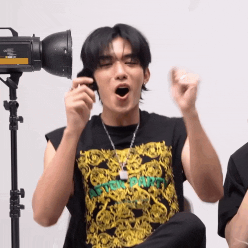 a man wearing a black shirt that says ' supreme ' on it is making a funny face