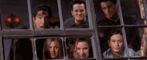 a group of friends looking out of a window .