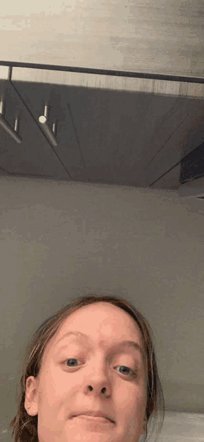 a woman with a red spot on her forehead is making a funny face
