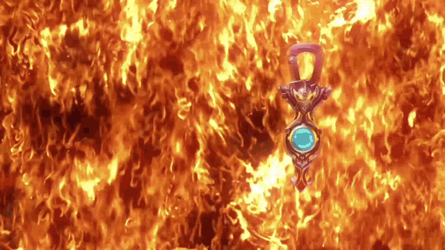a necklace with a blue stone is surrounded by fire