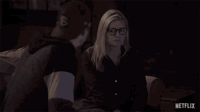 a man and a woman are sitting next to each other and a netflix logo is visible in the corner