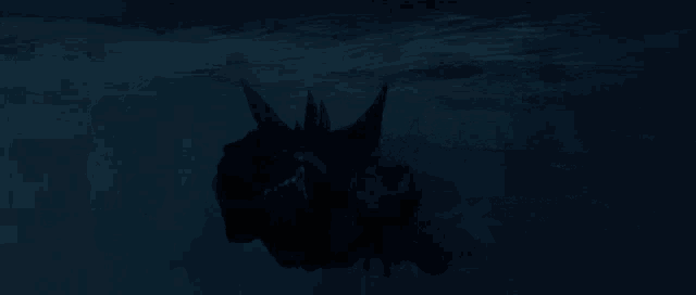 a large monster is swimming in the dark water