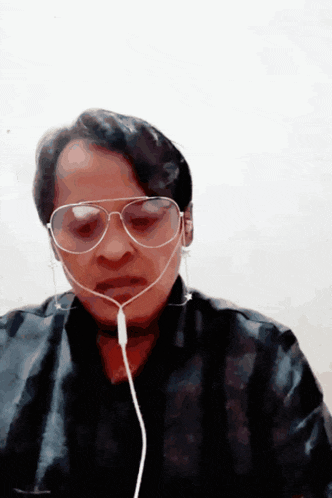 a man wearing a pair of sunglasses and earbuds