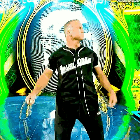 a man in a black baseball jersey is standing in front of a green and yellow background .