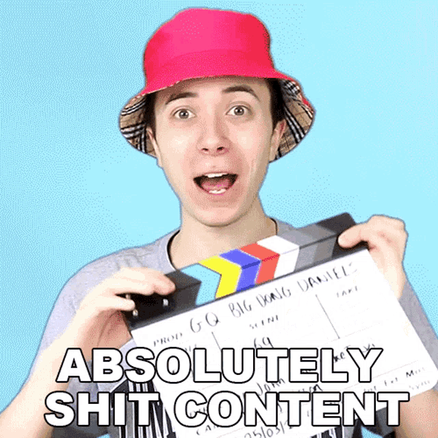 a man in a red hat is holding a clapper board with the words absolutely shit content written on it