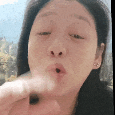 a close up of a woman 's face with her eyes closed