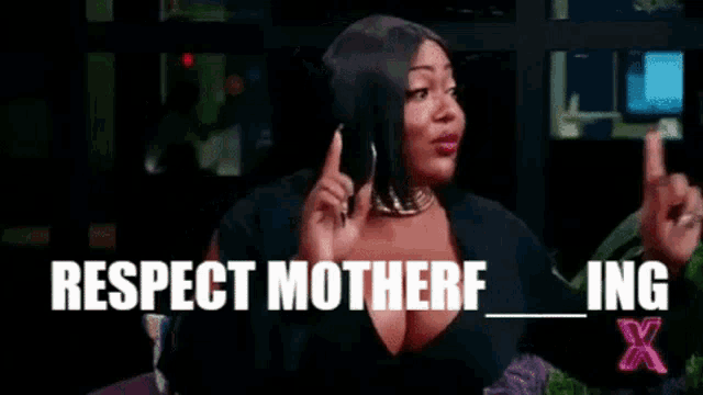 a woman in a black dress is sitting in front of a window with the words `` respect motherf ing '' written on it .