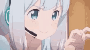 a girl with white hair and blue eyes is wearing a headset .
