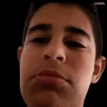 a close up of a young man 's face with his mouth open .