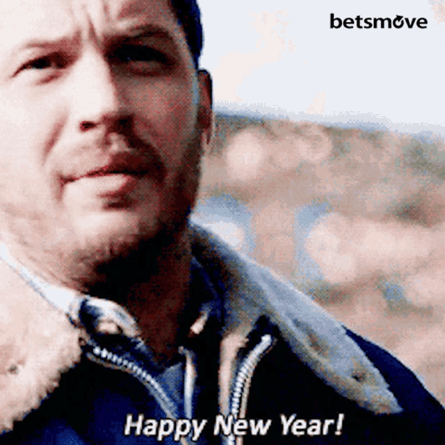 a man in a jacket says " happy new year " in front of a betsmove logo