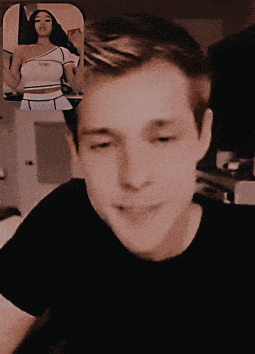 a man in a black shirt is smiling in front of a woman in a white top