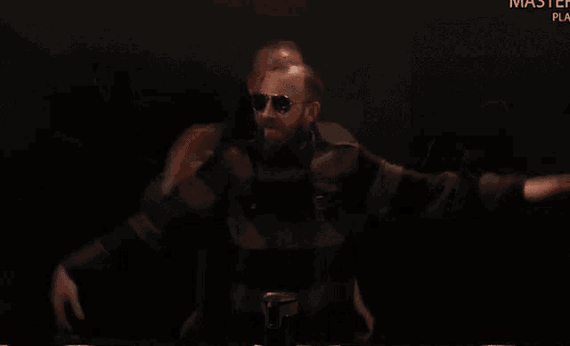 a man wearing sunglasses is dancing in front of a sign that says master