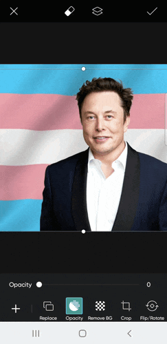 a man in a suit with a transgender flag behind him