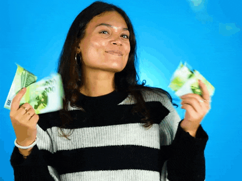 a woman in a striped sweater is holding a stack of 100 dollar bills in her hands