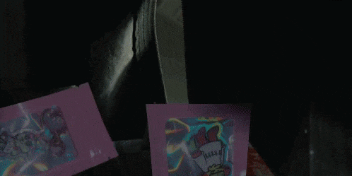 a person in a clown mask is holding a pink piece of paper that says jesus