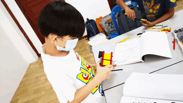 a boy wearing a mask and a shirt that says ' snoopy ' on it