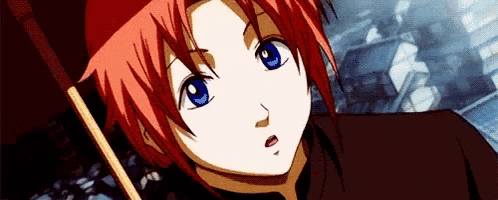 a close up of a person with red hair and blue eyes holding a stick .