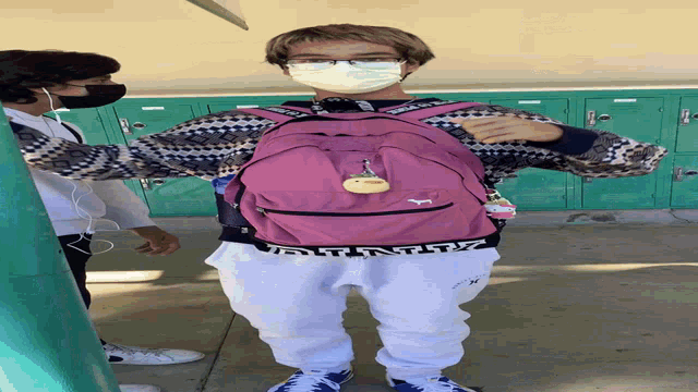 a person wearing a pink backpack with the word pink on the bottom