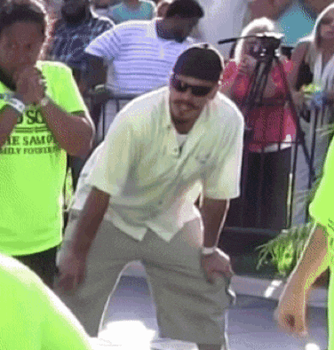 a man wearing sunglasses stands in front of a crowd wearing a shirt that says " so "