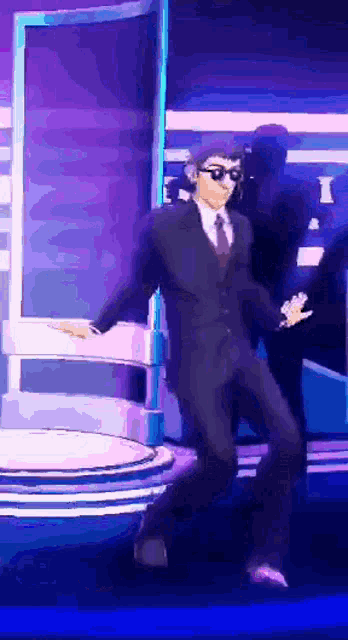 a man in a suit and tie dancing on a stage