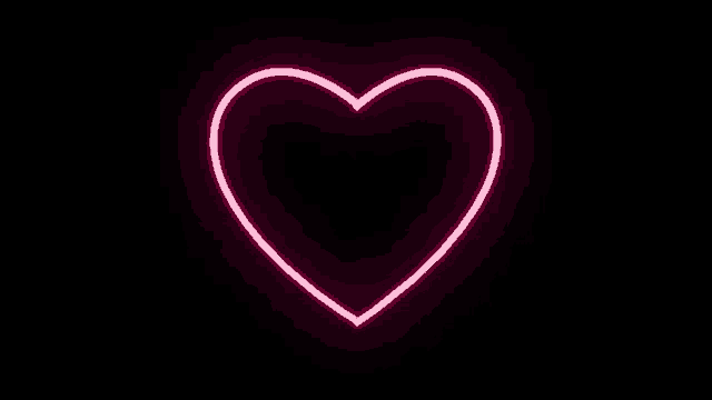 a pink neon heart is glowing on a black background