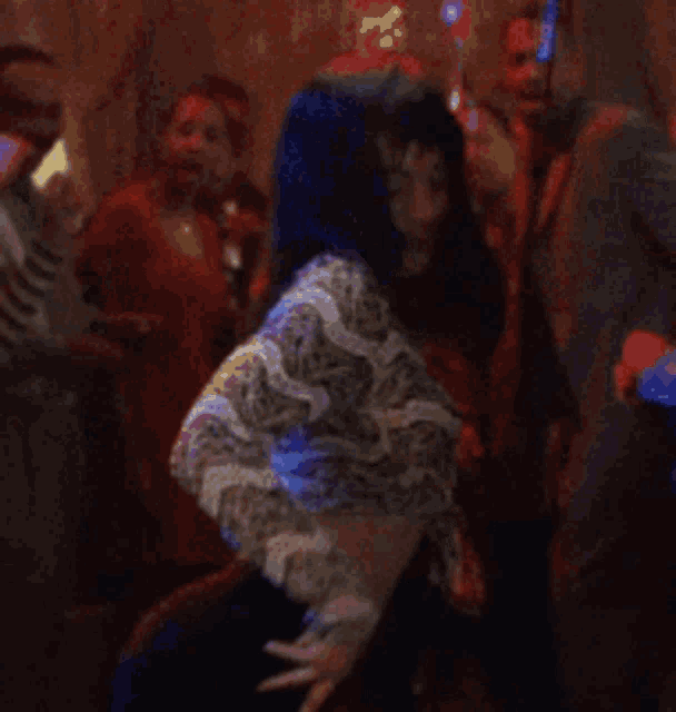 a blurry picture of a woman dancing in a crowd