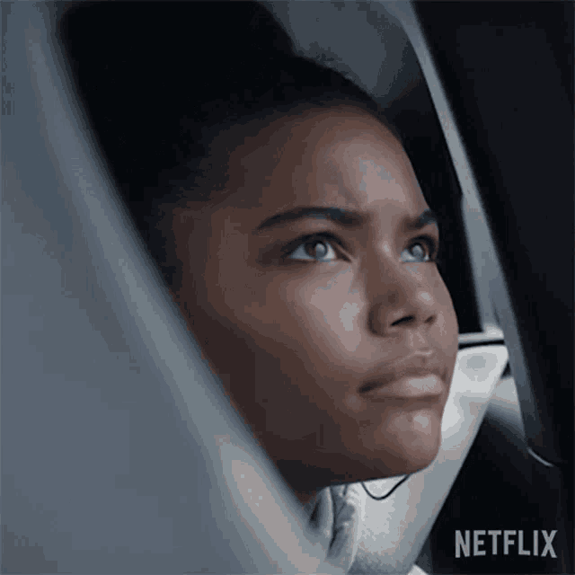 a woman is looking out of a car window with netflix written on the bottom right