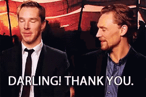 two men in suits and ties are standing next to each other and one of them is saying darling ! thank you .