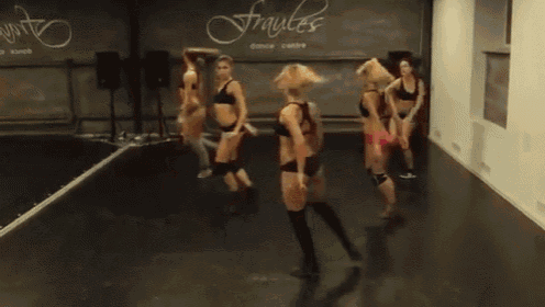 a group of girls are dancing in front of a fraules dance centre sign