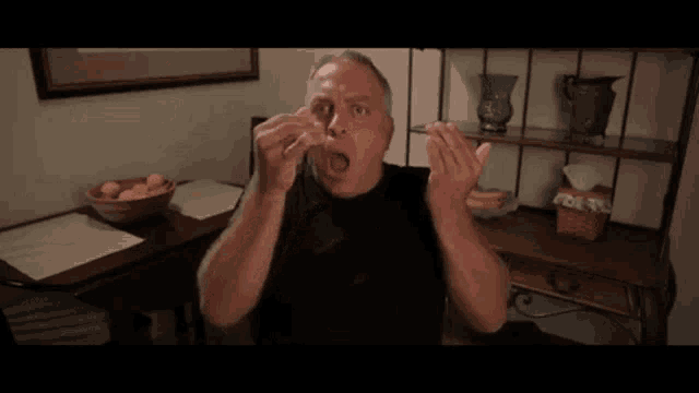 a man is clapping his hands in front of a table