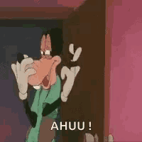a goofy cartoon character is standing in front of a door and shouting a huuu !