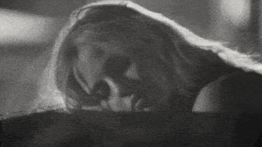 a black and white photo of a woman with a scary face