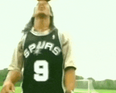 a man wearing a spurs jersey with the number 9 on it is standing on a field .