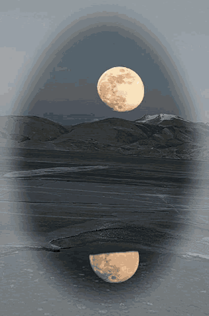 a full moon is reflected in a frozen body of water