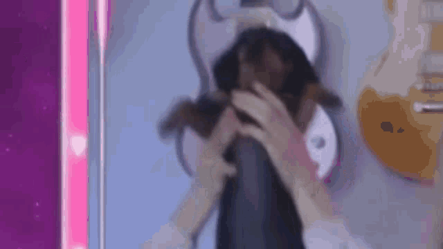 a person is holding a stuffed animal in front of a mirror .