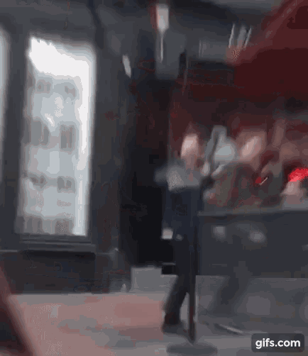 a blurry picture of a person standing in front of a fridge