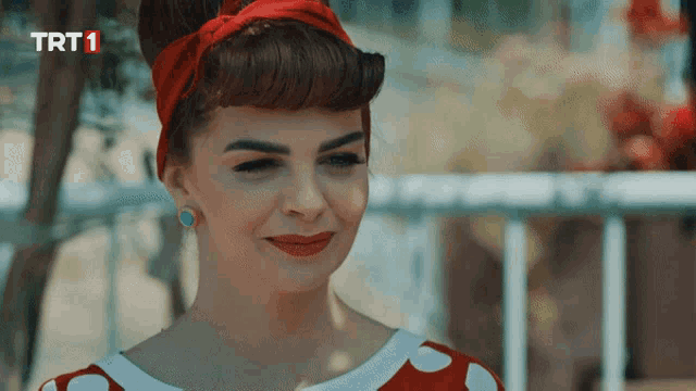 a woman in a red and white polka dot dress with trt1 written on the bottom right