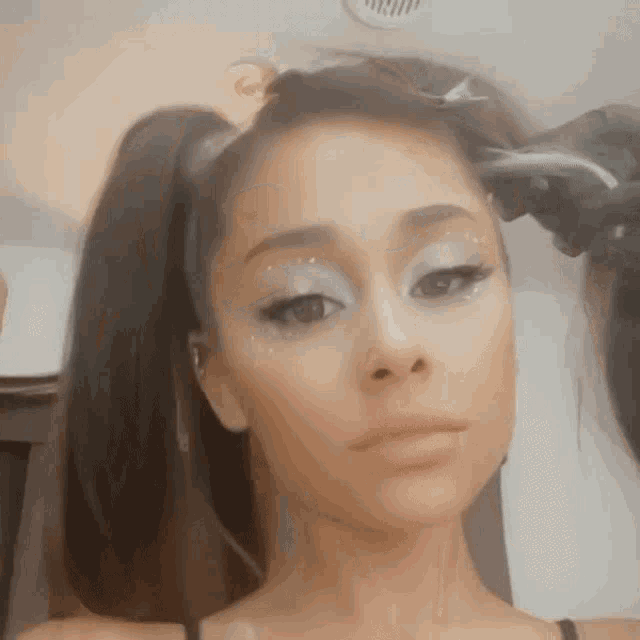 a close up of a woman 's face with two pigtails