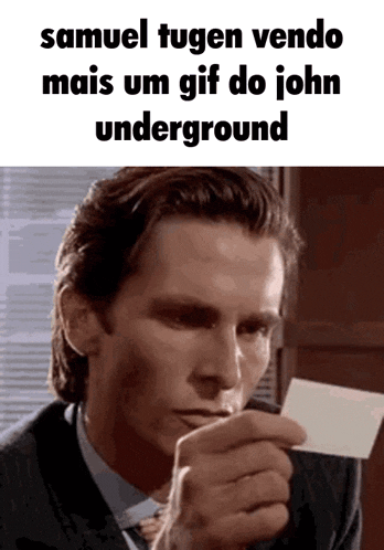 a man in a suit and tie is holding a piece of paper that says samuel tugen vendo mais um gif do john underground