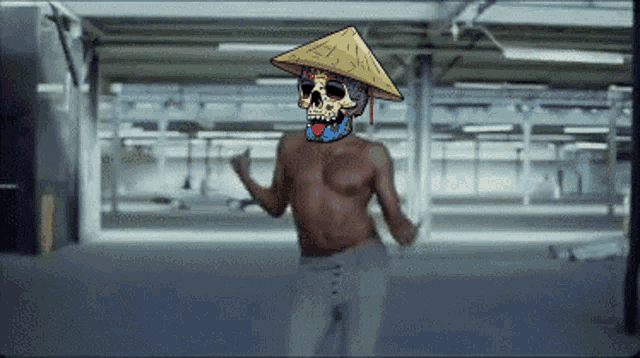 a shirtless man with a colorful skull on his face wearing a conical hat